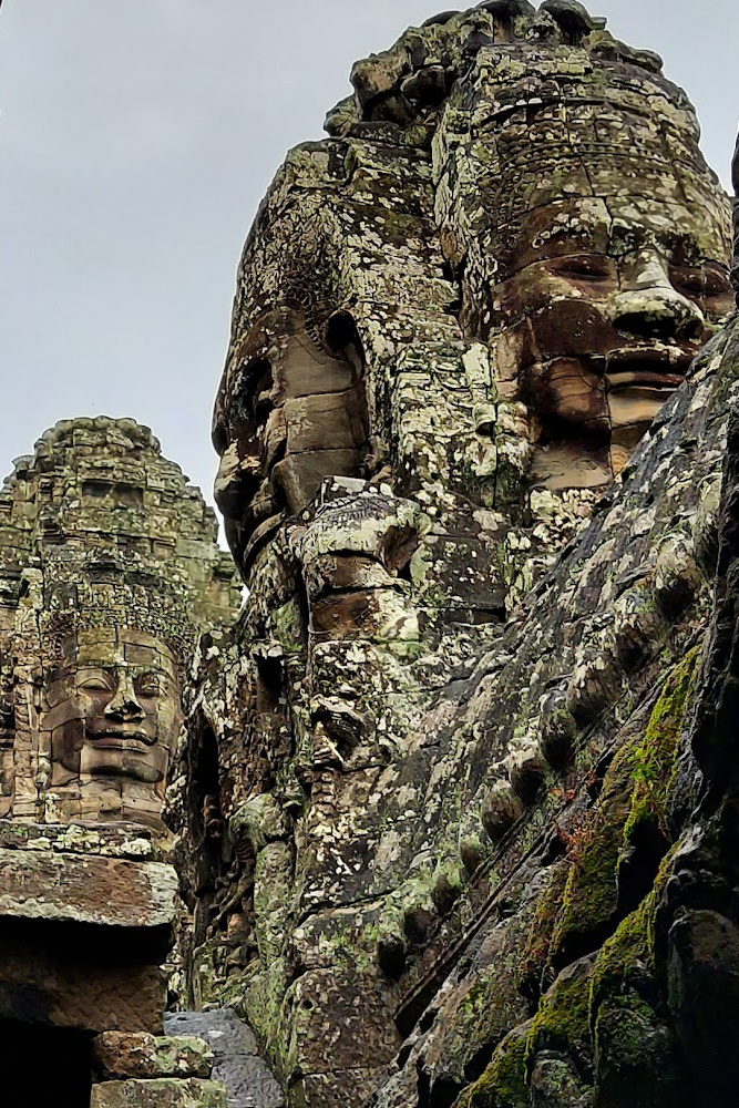 Close-up of Bayon Temple's serene stone faces, a highlight of the Angkor Thom area. Explore Angkor Wat in Siem Reap.