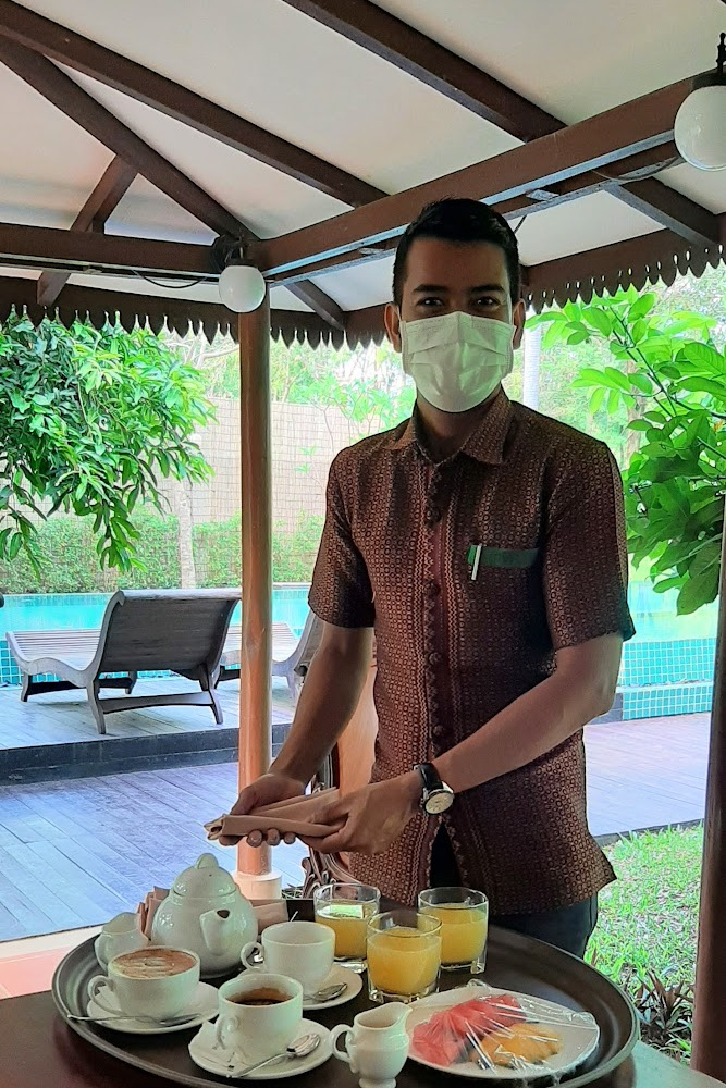 Personal butler serving breakfast by the pool at Mane Family Vacation villa