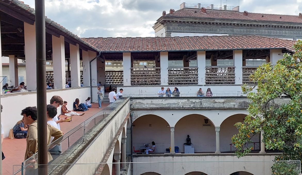 Students and visitors enjoying rooftop café at Biblioteca delle Oblate with Duomo views