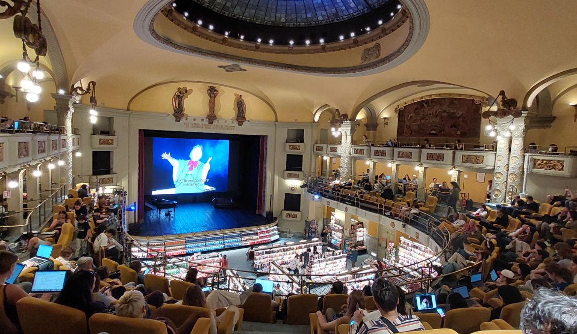 Interior of Giunti Odeon in Florence, a unique cinema-bookstore with a historic atmosphere and modern readers.