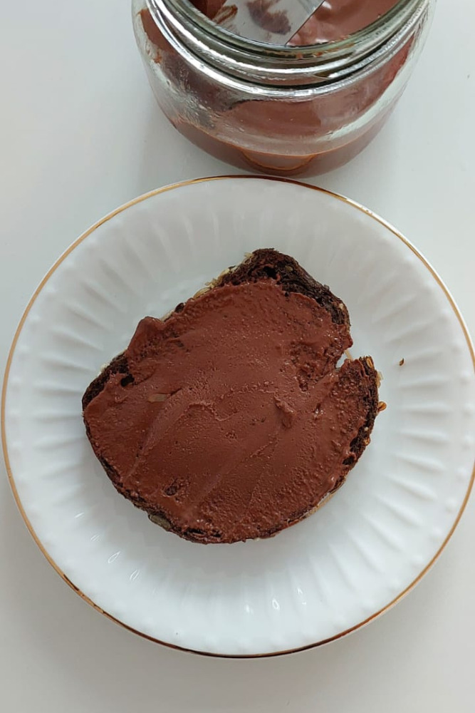 Homemade chocolate spread on rustic bread, dairy-free and plant-based recipe.