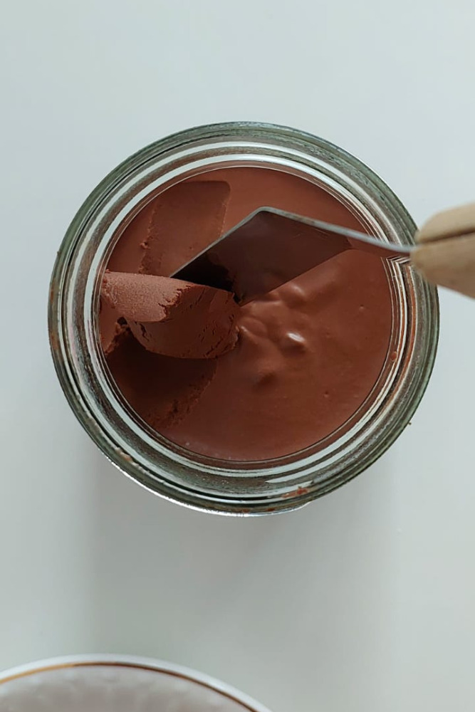 Homemade chocolate spread on rustic bread, dairy-free and plant-based recipe.