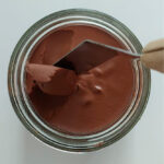 Smooth texture of homemade chocolate spread with cocoa powder.