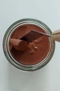 Smooth texture of homemade chocolate spread with cocoa powder.